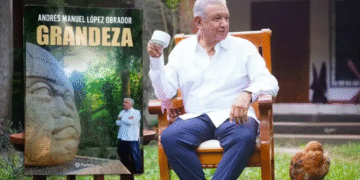 AMLO junto a la portada de su libro.